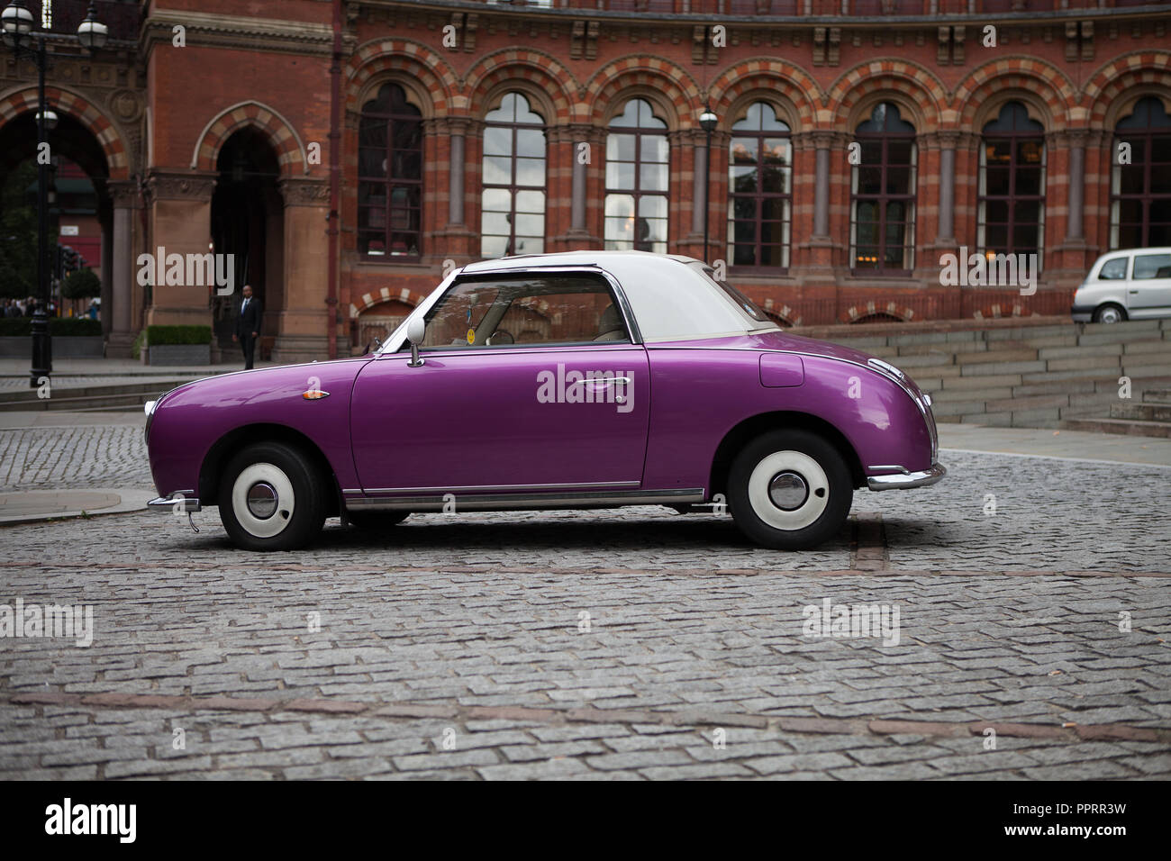 Nissan Figaro parked in front of the Midland Grand Hotel, St. Pancras, London, UK. Stock Photo