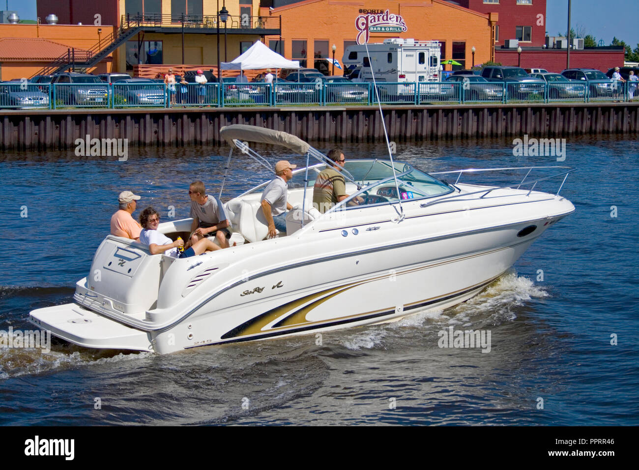 Family riding in a luxury inboard Sea Ray speedboat watercraft in