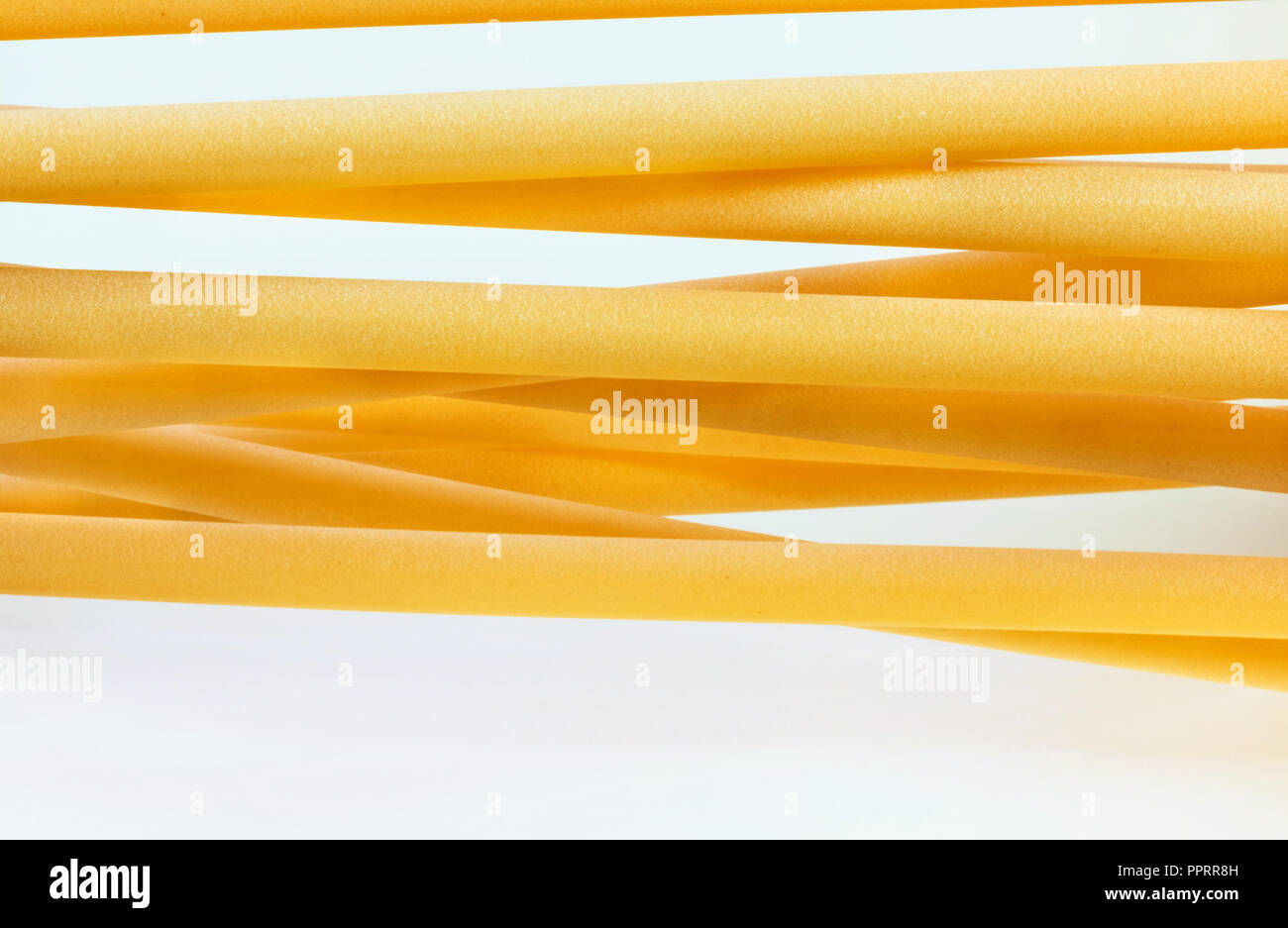 A group of Italian pasta called ziti on a white background ,long empty