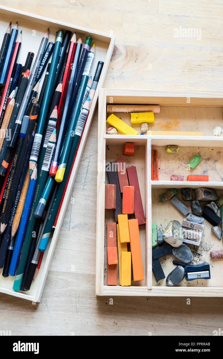 Artist's materials. Pencils, pastels and other art materials in wooden boxes. Stock Photo