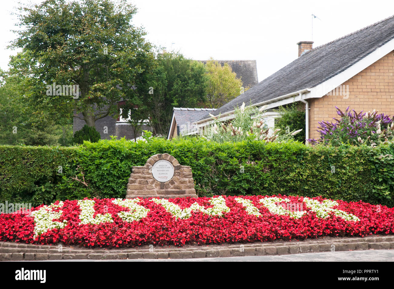 Red and White Begonia semperflorens in flower bed spelling out the name of village Elswick. Winner of Lancashire Best kept village.medium class 2010. Stock Photo