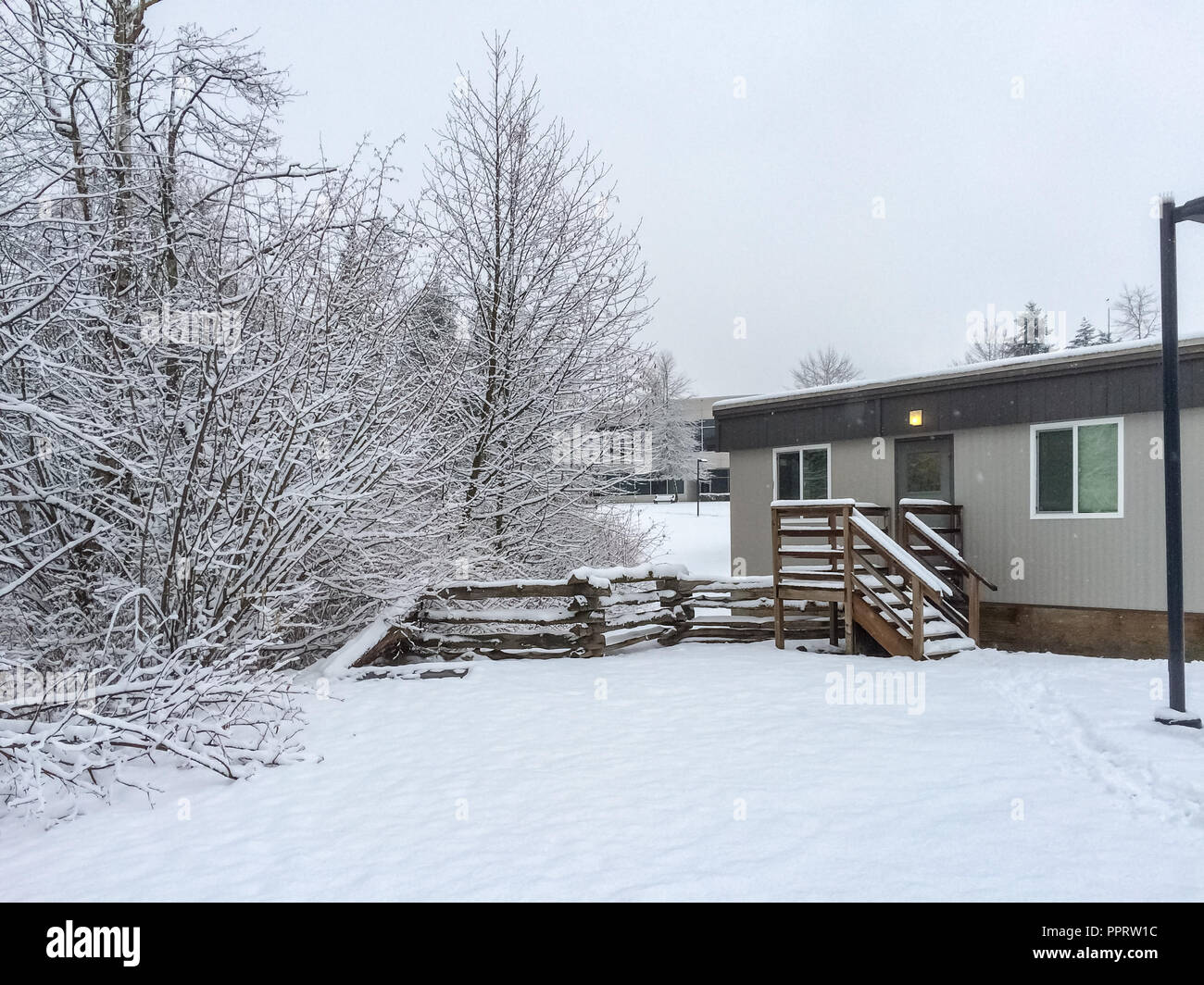 Small yard covered with snow in front of the house on winter day in Canada Stock Photo