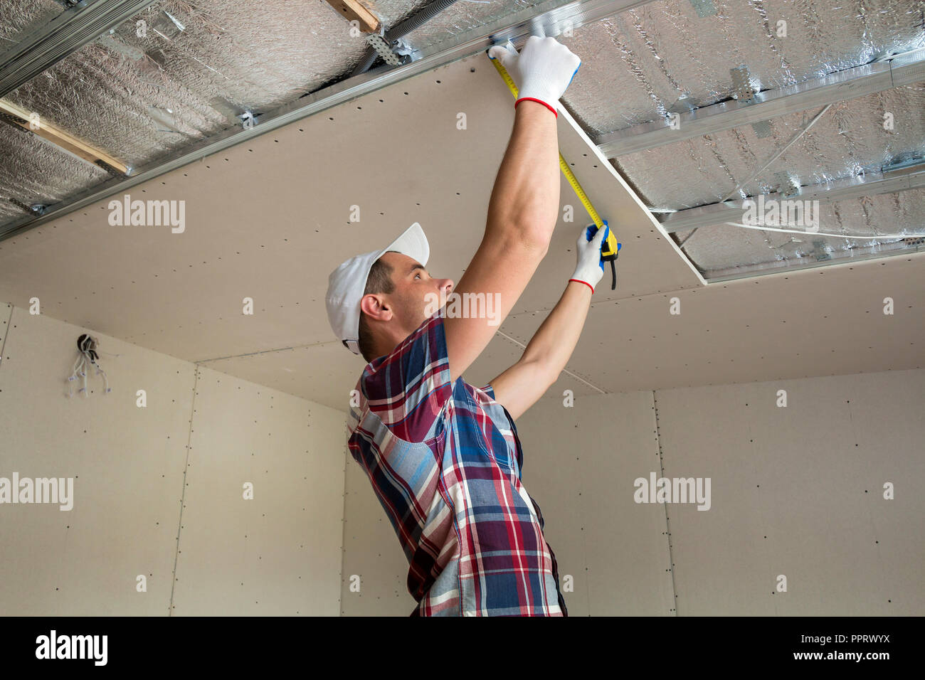 Young Handsome Man In Casual Clothing Takes Measurement Of