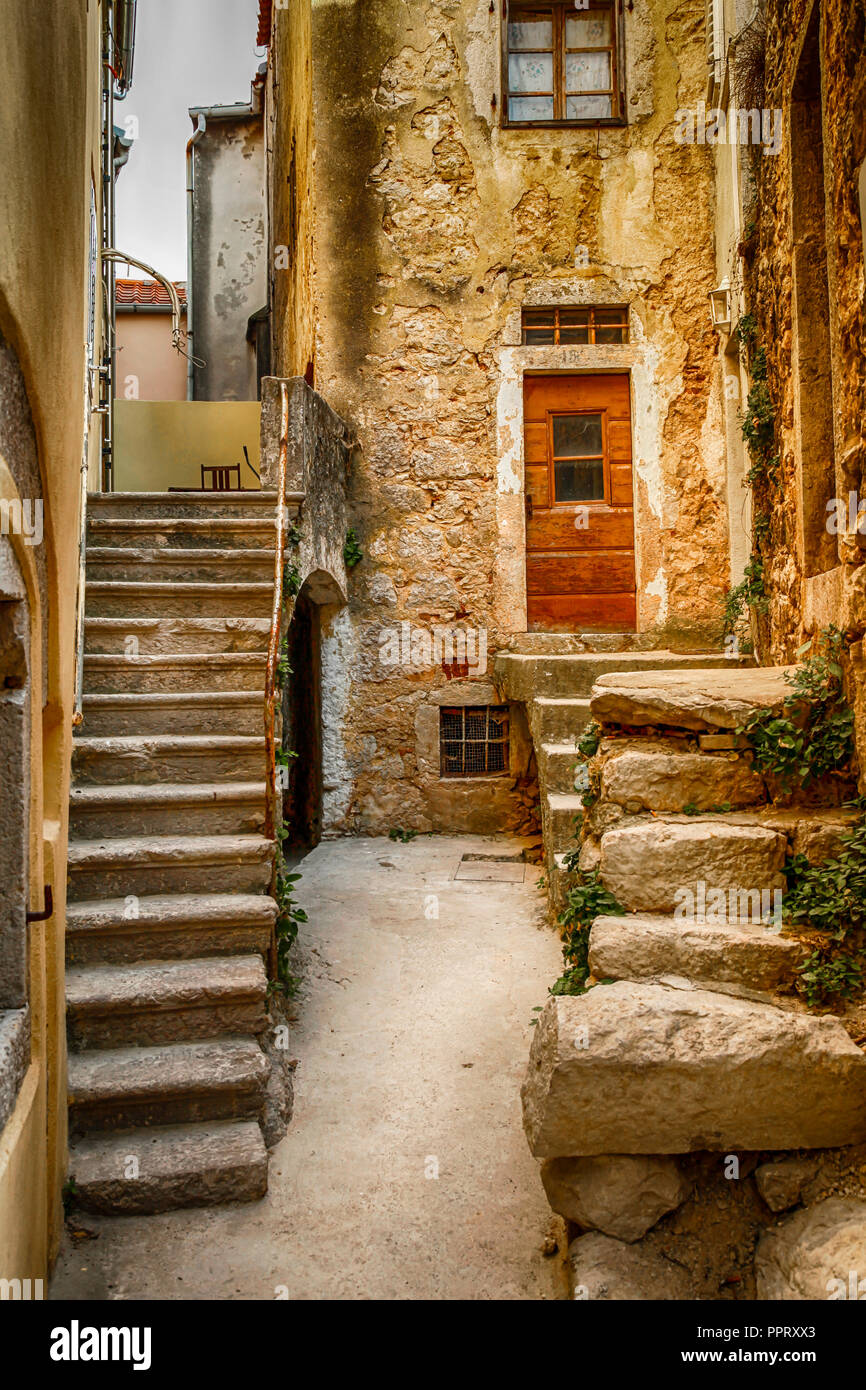 The medieval interwoven labyrinths of stone alleys and stairs, balconies and shutters accent the village of Vrbnik on the Croatian island of Krk Stock Photo