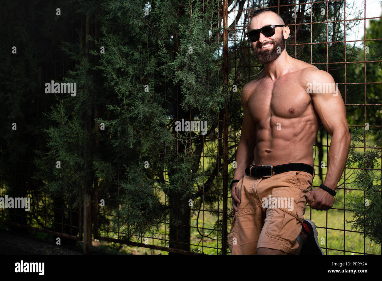 Portrait of a Young Physically Fit Man Showing His Well Trained Body - Muscular Athletic Bodybuilder Fitness Model Posing Outdoors - a Place for Your  Stock Photo