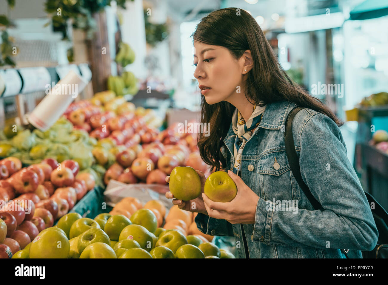 young traveler buying fruits in the original farmers market, she