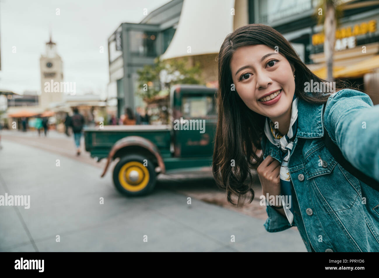 pretty tourist taking selfie, full of happiness on her face, she is telling how wonderful the journey is Stock Photo