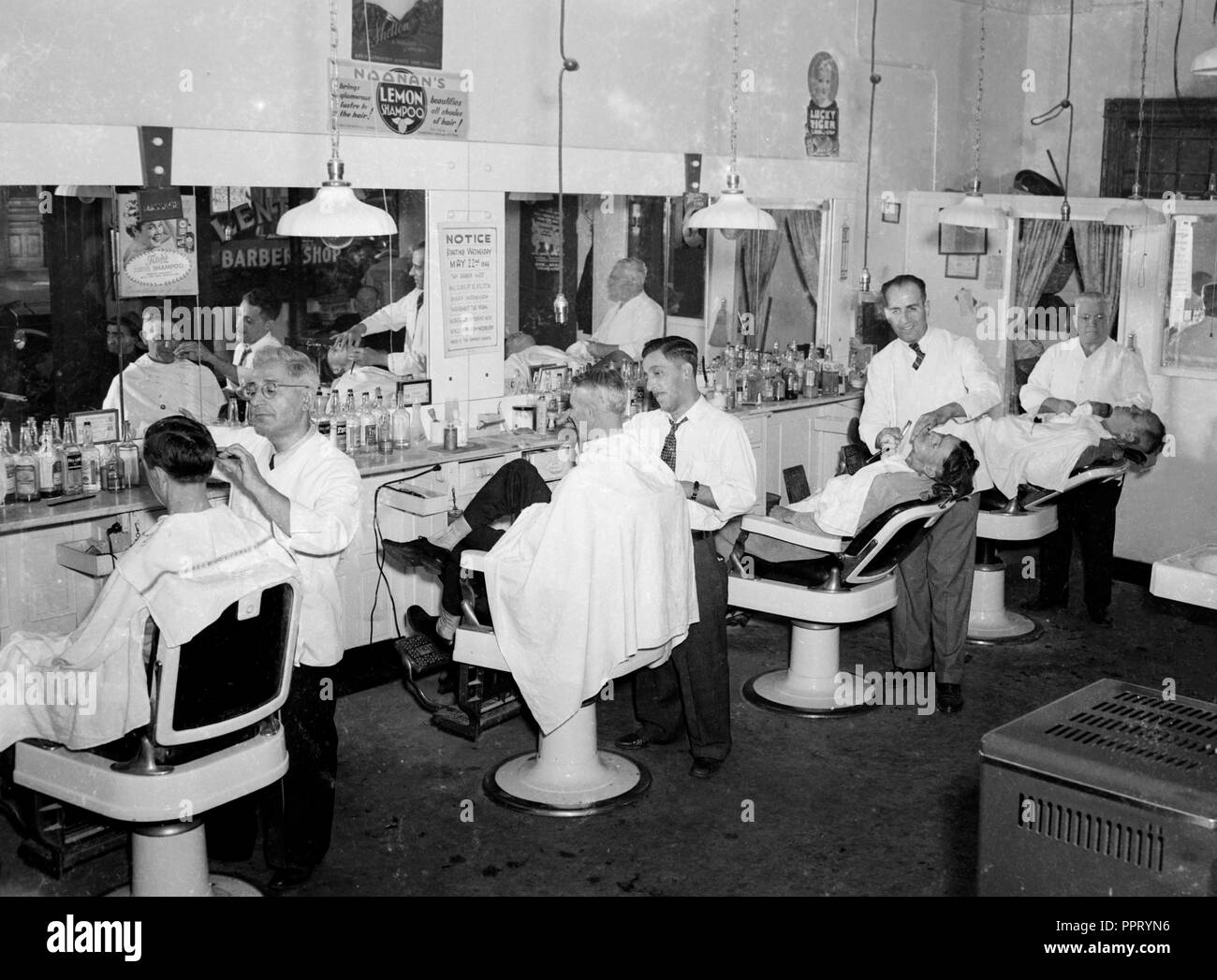 Barbershop scene in the US, ca. 1940. Stock Photo