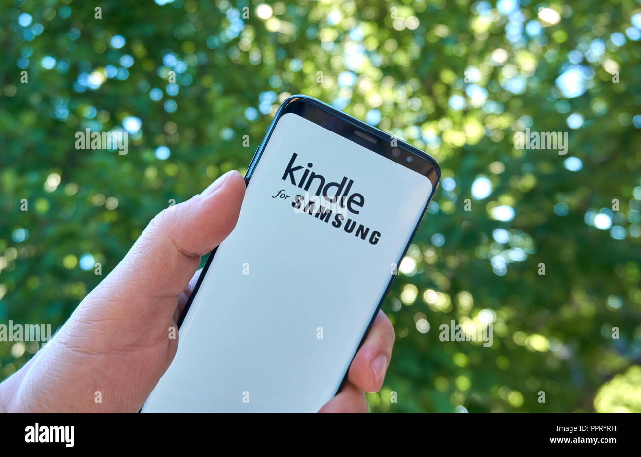 MONTREAL, CANADA - August 28, 2018: Amazon Kindle for Samsung android app on Samsung s8 screen in a hand. Stock Photo