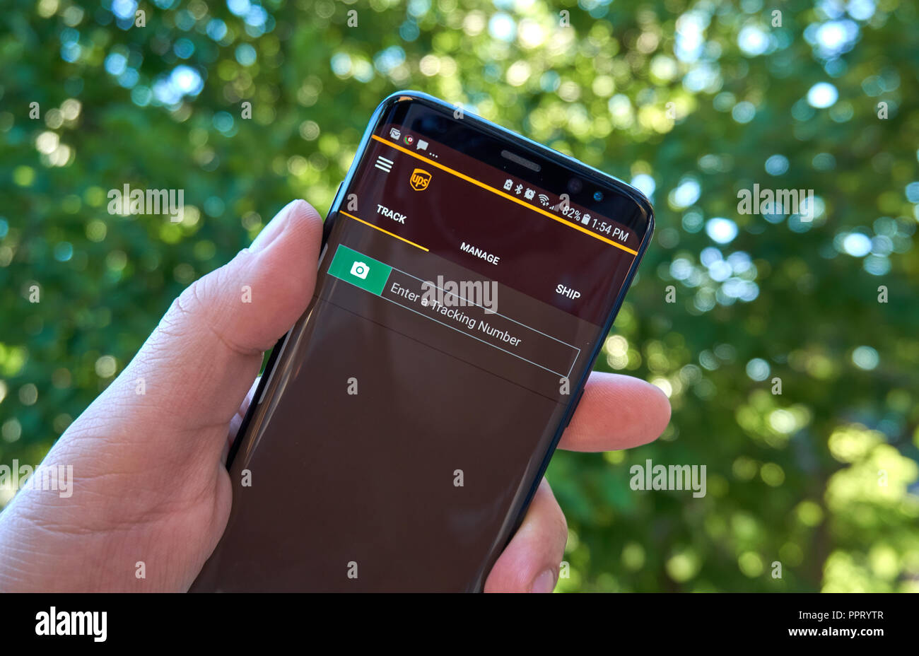 MONTREAL, CANADA - August 28, 2018: UPS tracking android app on Samsung s8 screen in a hand. Stock Photo