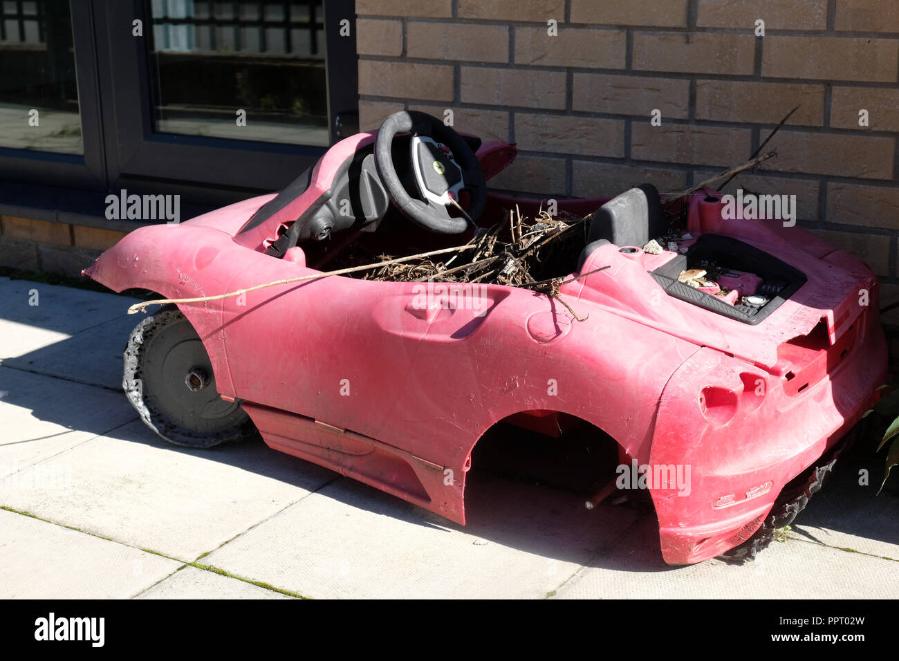 September 2018 Old childs toy car left with rubbish in it in a front