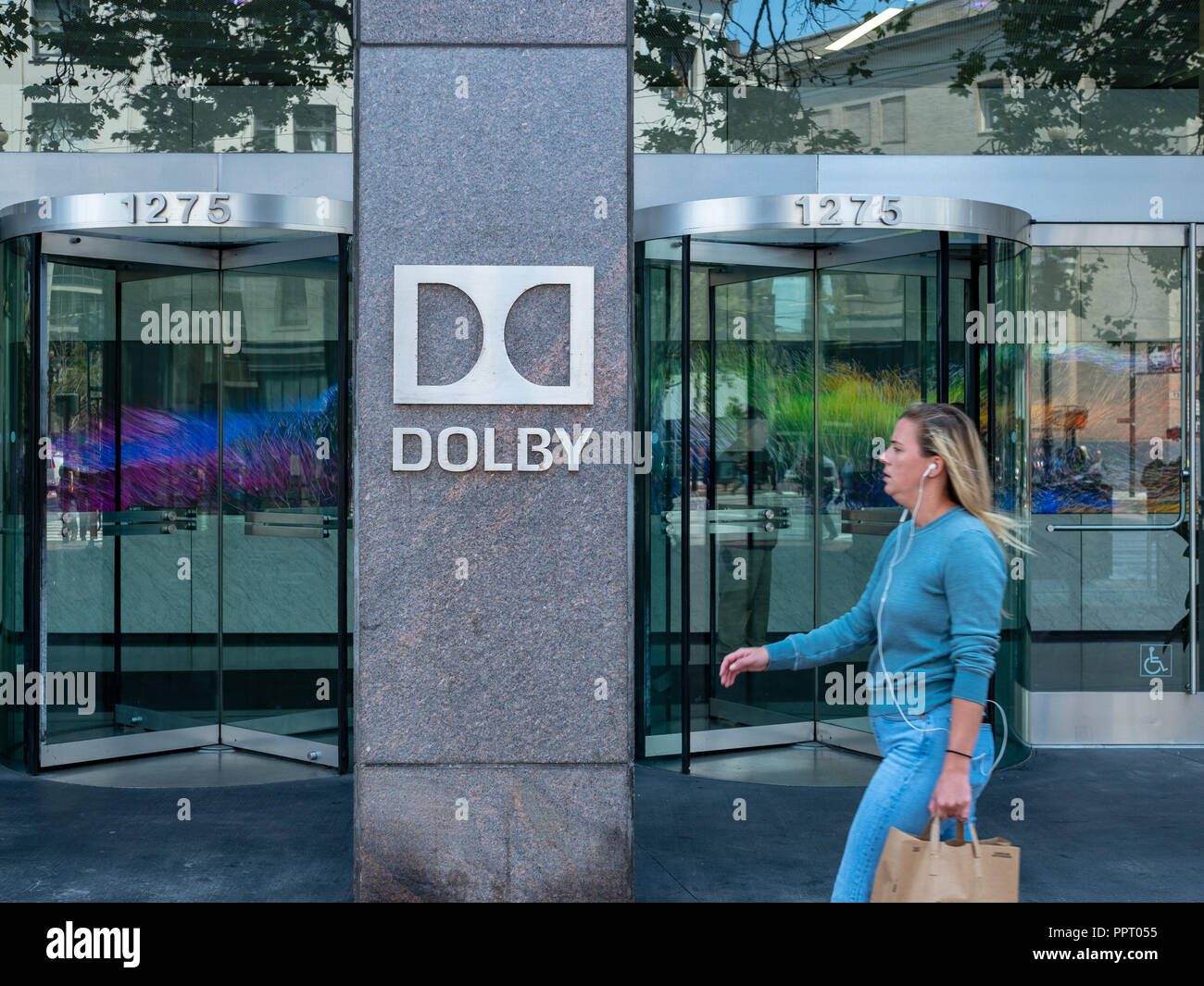 SAN FRANCISCO, CA August 8, 2018: Woman walks by Dolby Laboratories headquarters sign Stock Photo