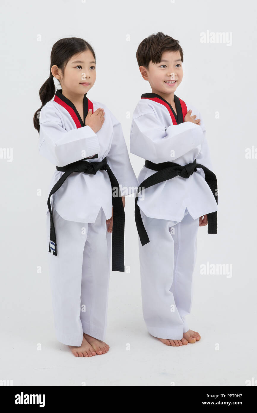 Children education. Taekwondo, little boy and girl practice martial
