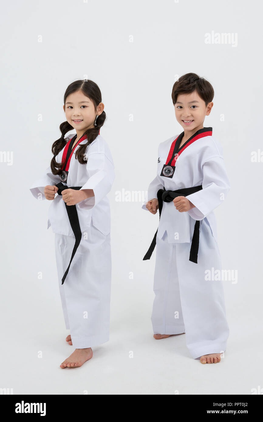 Children education. Taekwondo, little boy and girl practice martial arts in  white background 247 Stock Photo - Alamy
