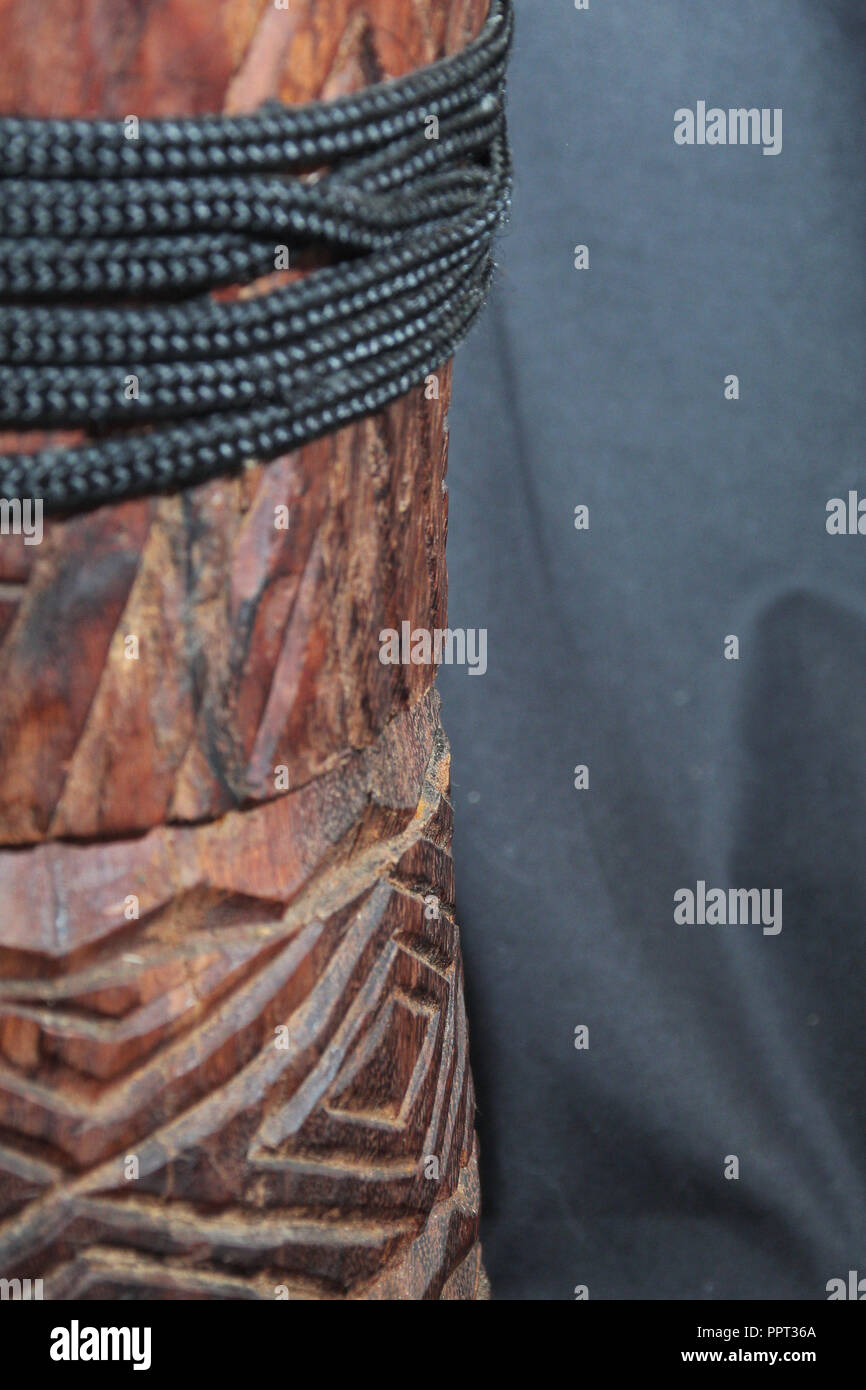 up-close view of a wooden African djembe design with tuning ropes on the left side of the frame Stock Photo