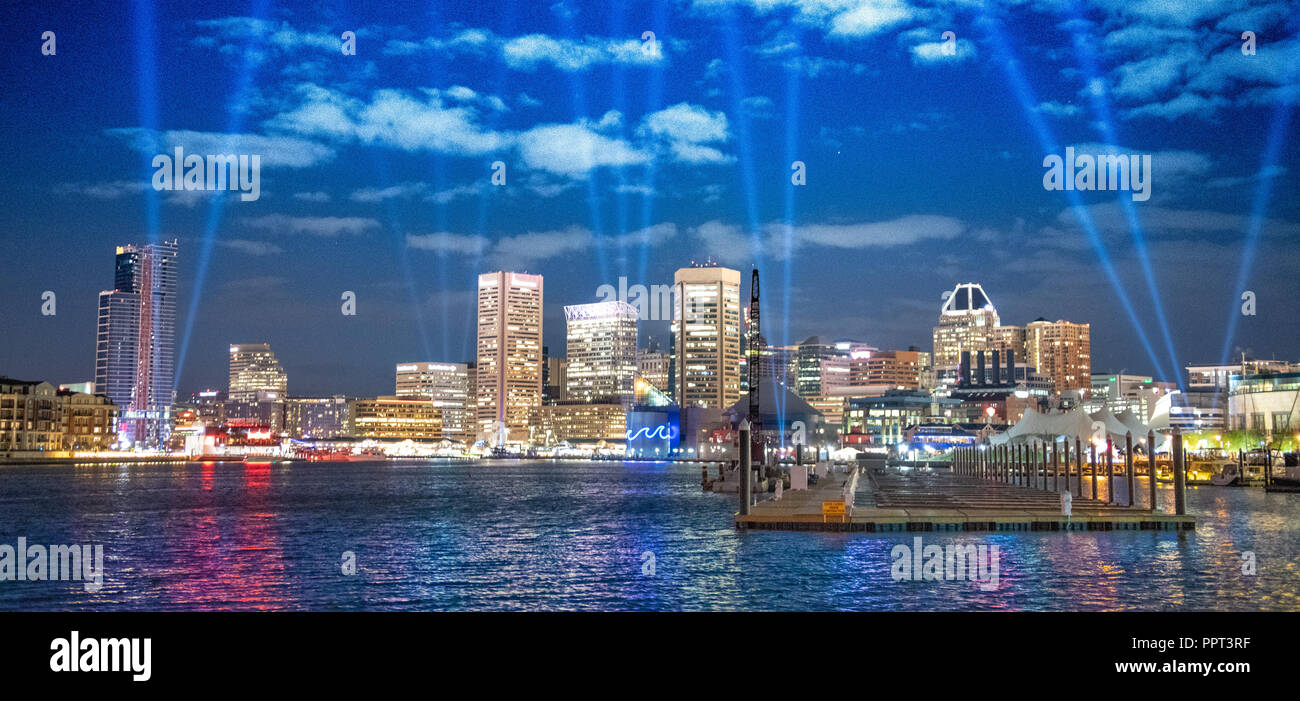 The Baltimore harbor lit up for Light City while search lights draw  attraction to the event. Baltimore, MD Stock Photo - Alamy