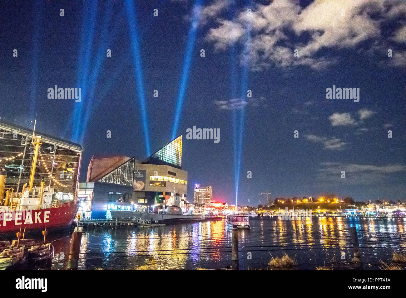 The Baltimore harbor lit up for Light City while search lights draw  attraction to the event. Baltimore, MD Stock Photo - Alamy
