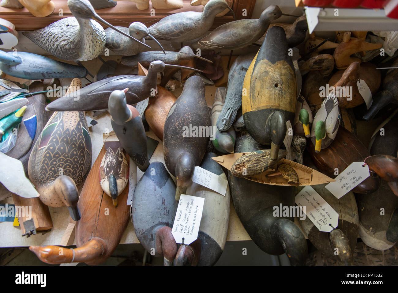 Handcrafted water fowl decoys stacked on a table. Stock Photo