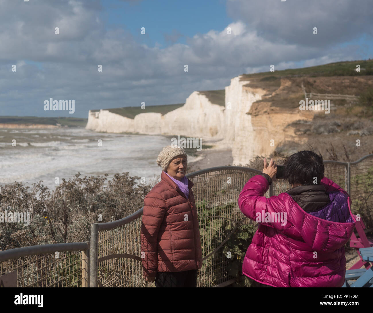 Tourists taking snapshot at Birling Gap, Sussex Stock Photo
