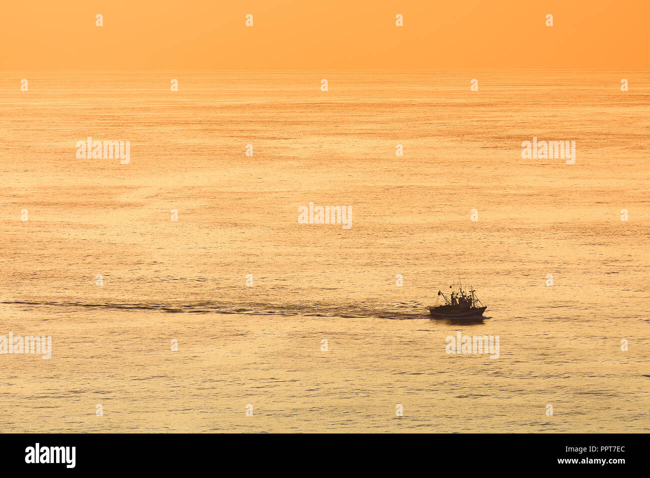 fishing ship at sunset Stock Photo - Alamy