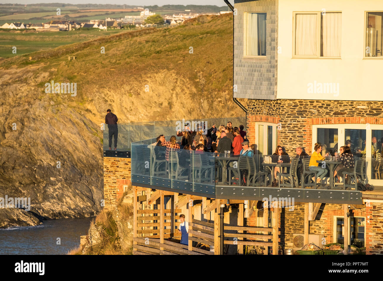 Customers relaxing on the balcony of the Lewinnick Lodge on East Pentire in Newquay in Cornwall. Stock Photo