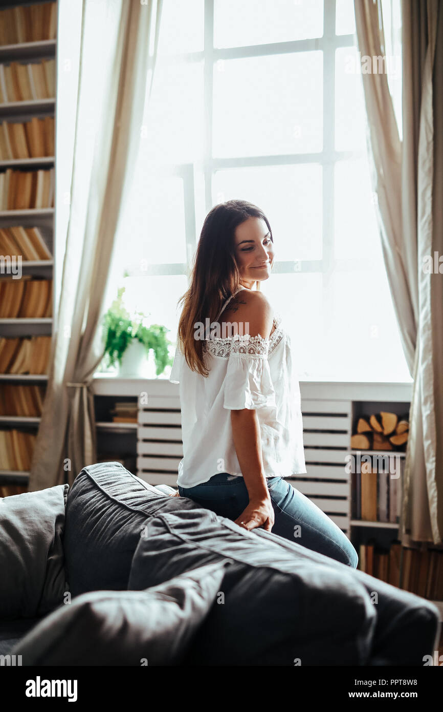 Woman girl sitting on sofa hi-res stock photography and images - Alamy