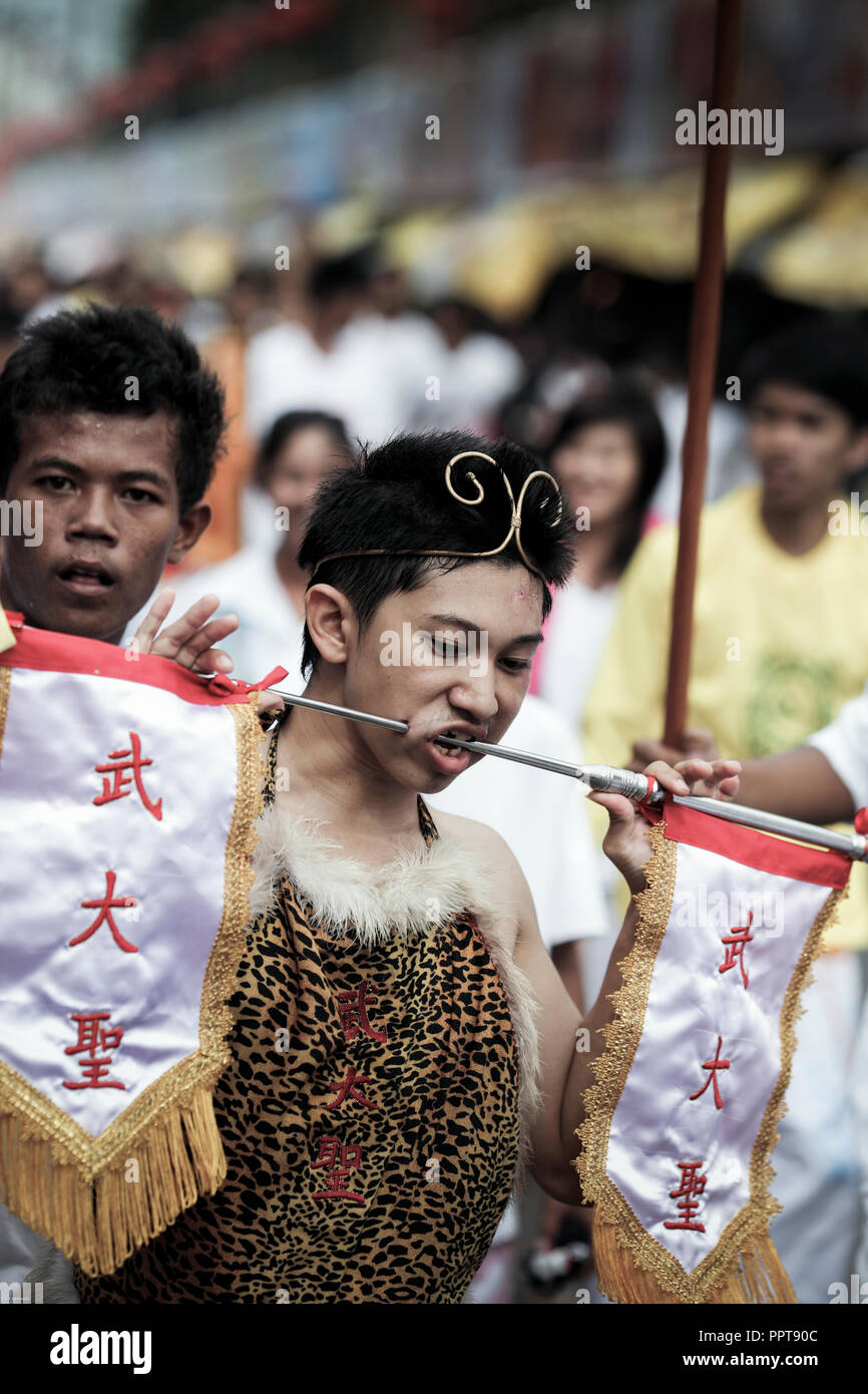 Spirit medium with piercings through cheeks and mouth in Phuket Vegetarian Festival, procession through the streets of Phuket Town, Thailand Stock Photo
