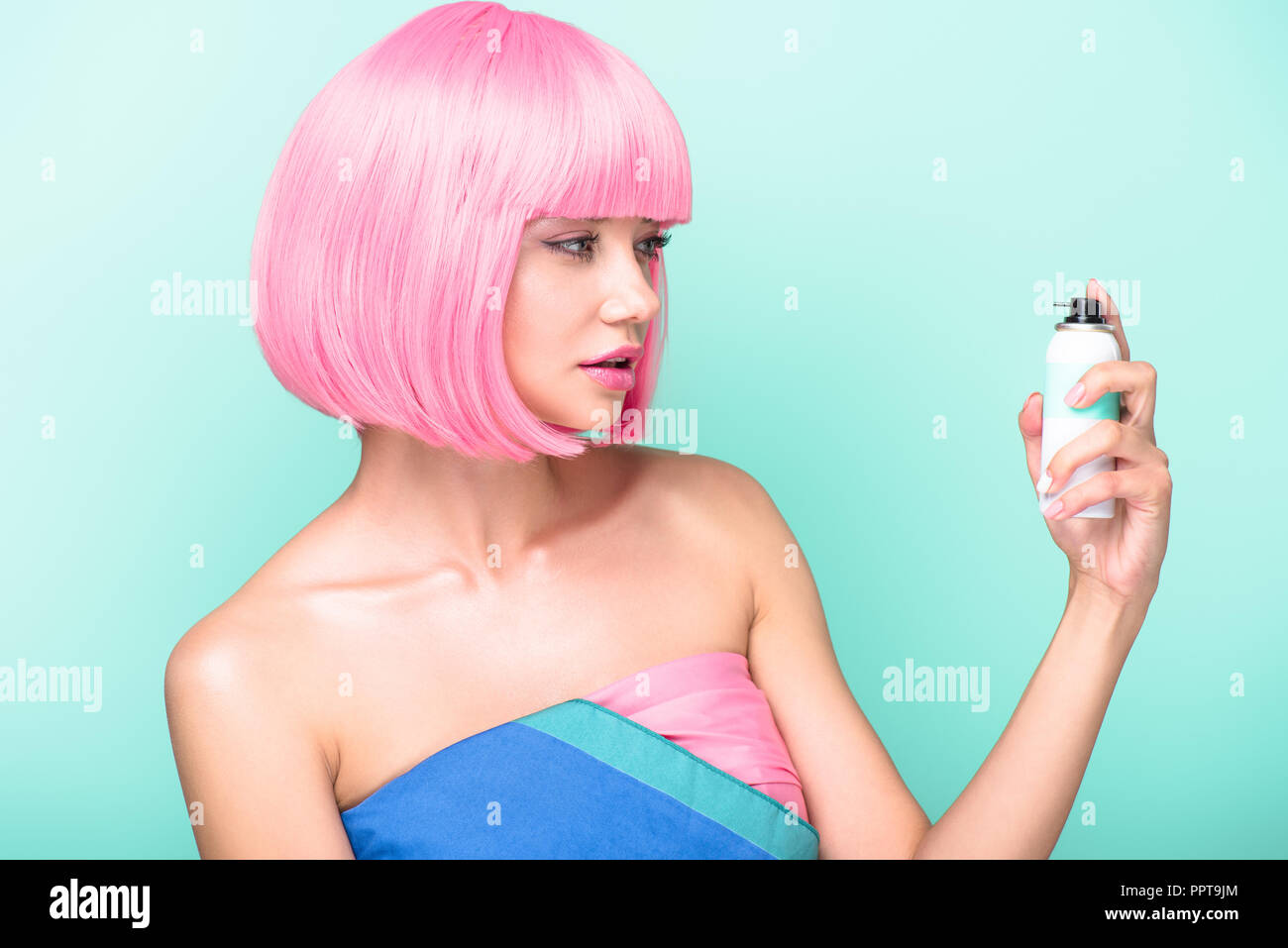 attractive fashionable girl in pink wig posing with scissors isolated on  blue Stock Photo by LightFieldStudios