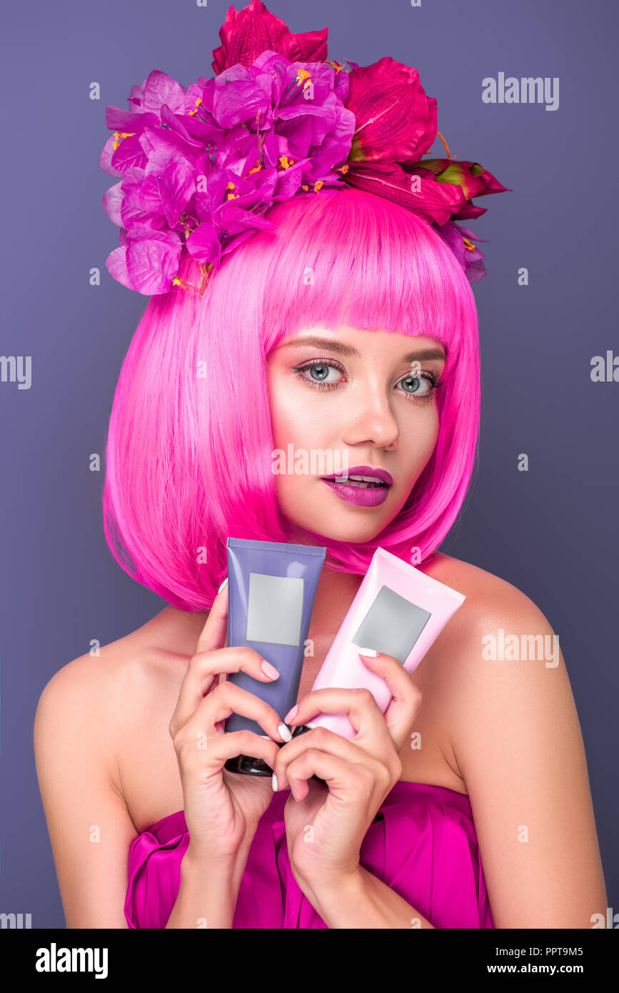 beautiful stylish girl in pink wig holding scissors isolated on pink, Stock image