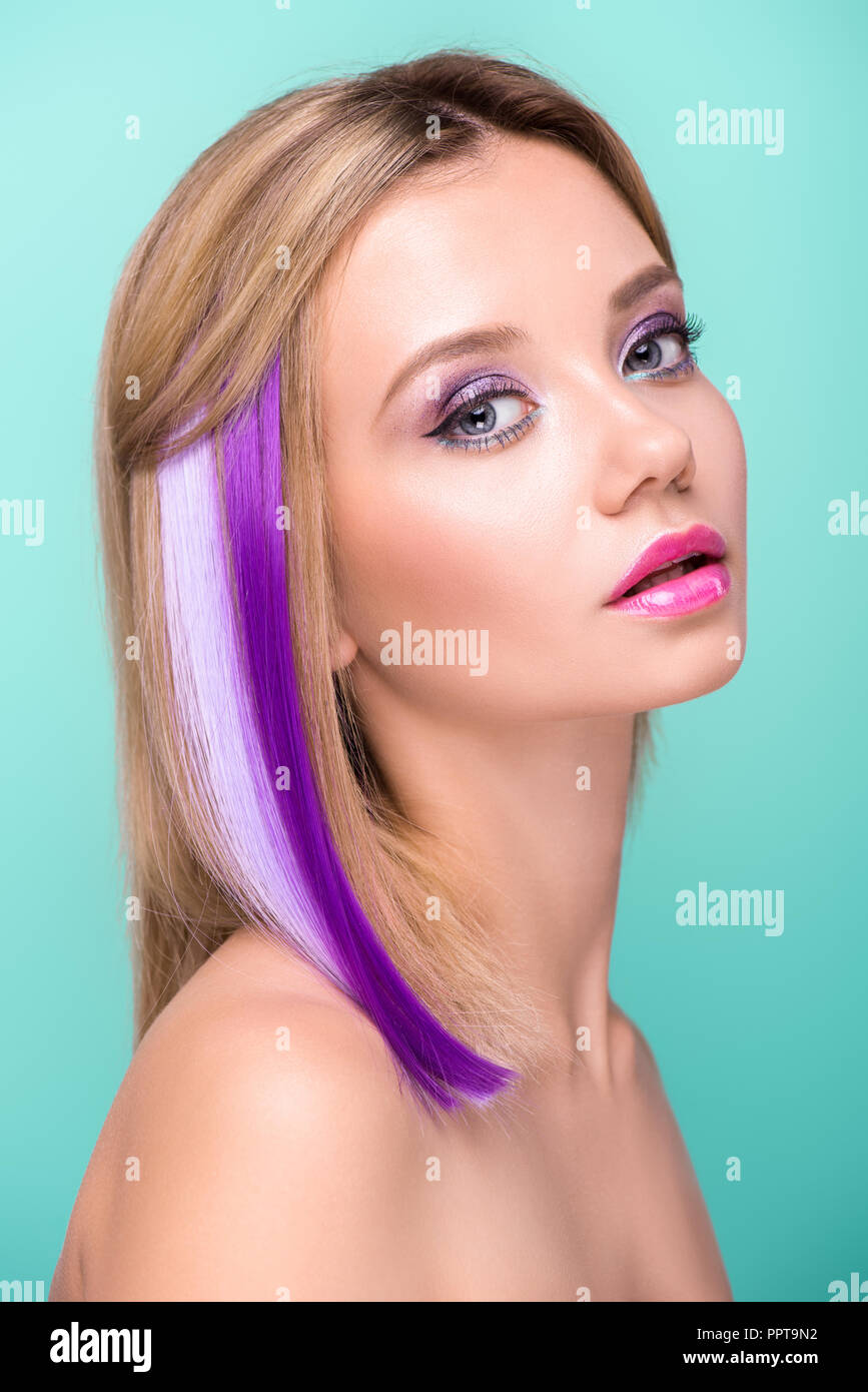 Attractive Young Woman With Bobbed Hair With Purple Strands Looking At Camera Isolated On Blue Stock Photo Alamy