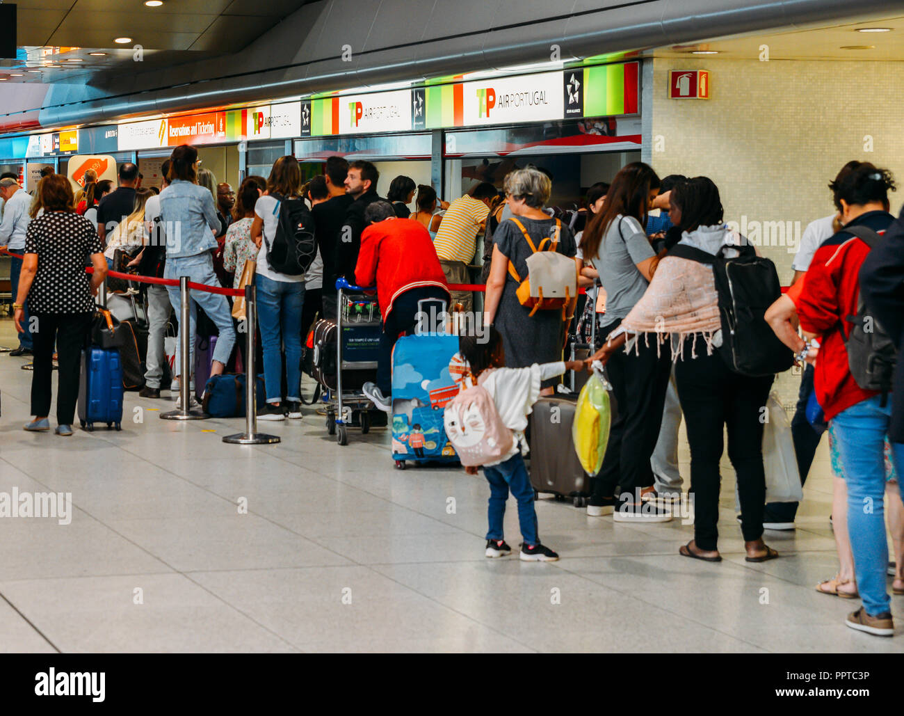 Lisbon, Portugal - Sept 26, 2018: Passsengers wait at a TAP customer service counter at departure Hall of Lisbon international airport, the largest in Stock Photo