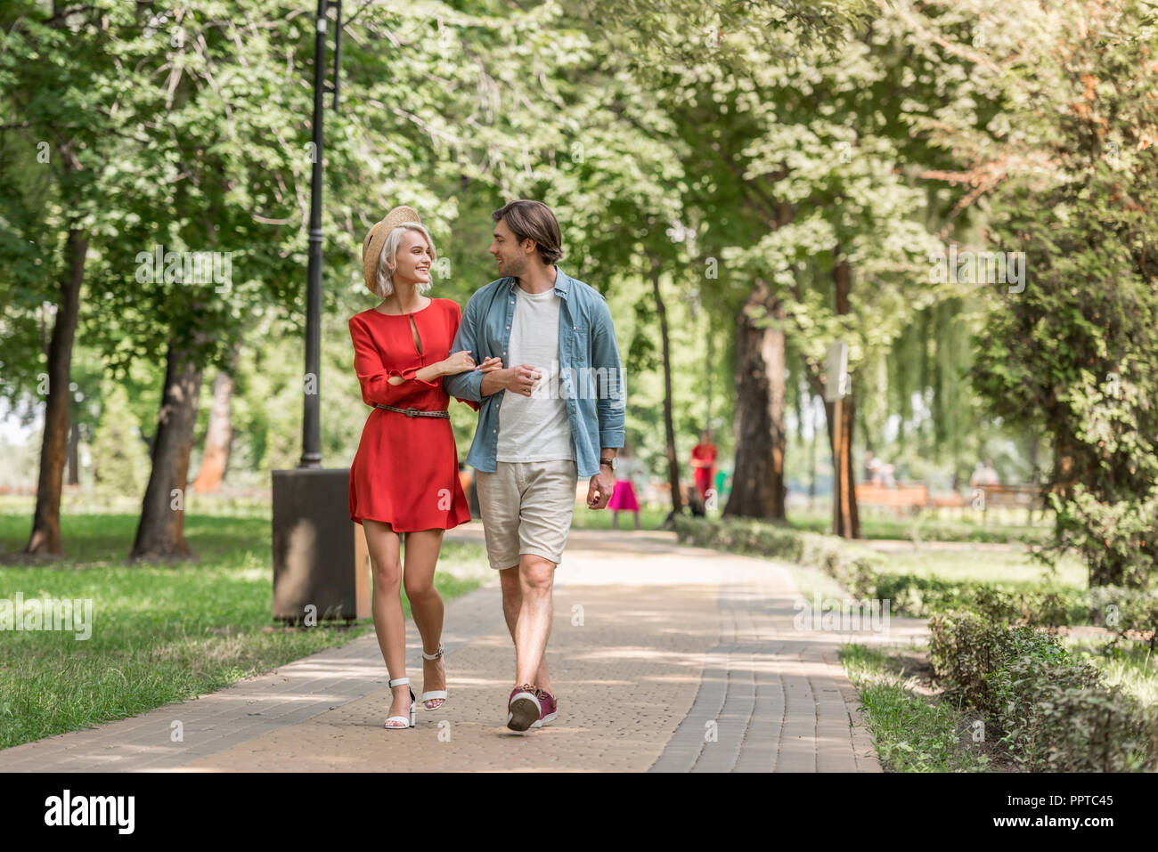 Girlfriend And Boyfriend Walking Together In Park And Looking Away Stock  Photo, Picture and Royalty Free Image. Image 107905852.