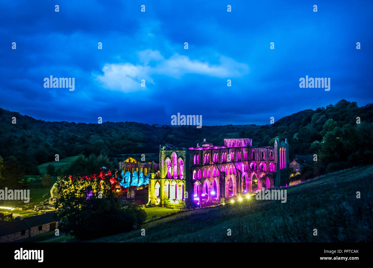 Rievaulx Abbey bathed in coloured light ahead of Illuminating Rievaulx, a three night light and sound installation at the 11th-century abbey ruins in North Yorkshire. Stock Photo