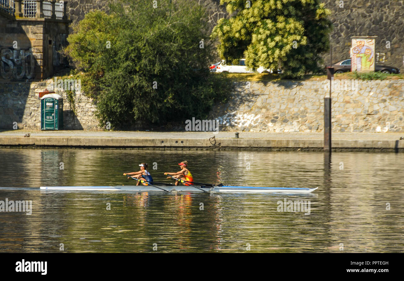 Two people training on a rowing boat on the River Vltava in the centre of Prague Stock Photo