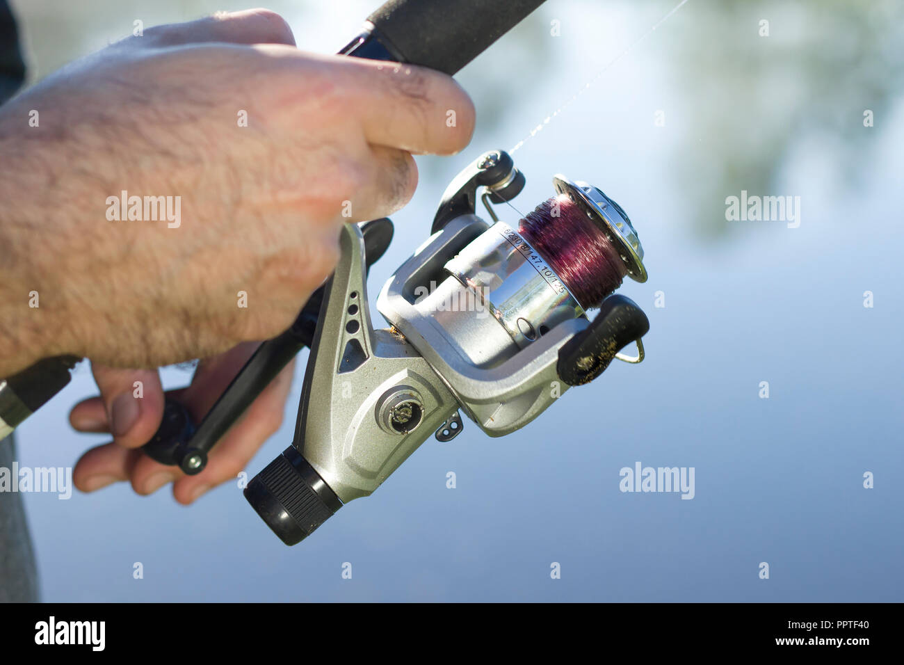https://c8.alamy.com/comp/PPTF40/angler-catches-fish-for-spinning-pulls-the-fishing-line-with-a-spinning-wheel-PPTF40.jpg