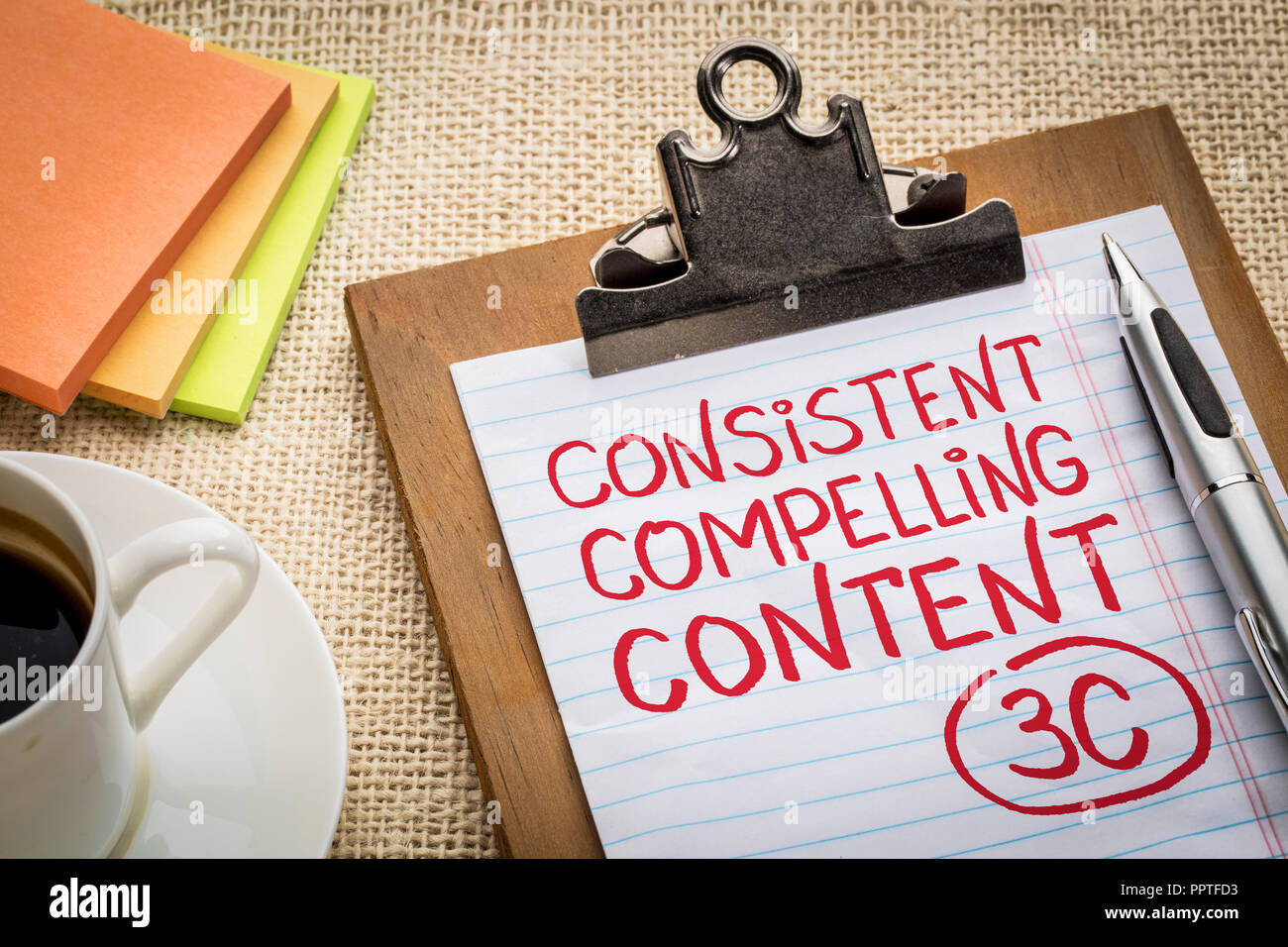 consistent, compelling content concept - handwriting on a clipboard ...