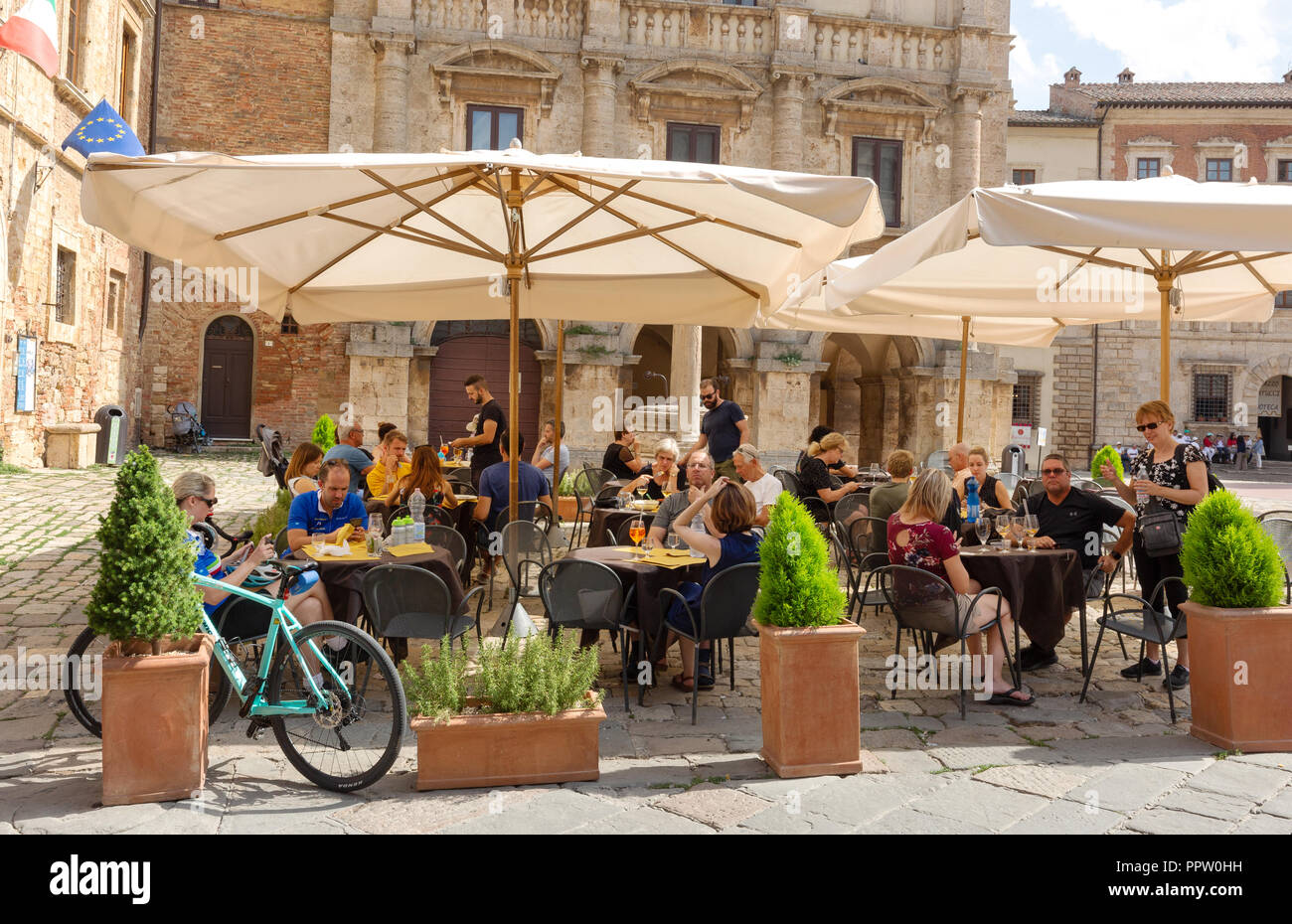 Italy cafe - people drinking outdoors in a tuscany cafe in the summer heat, Piazza Grande, Montepulciano Tuscany Italy Europe Stock Photo