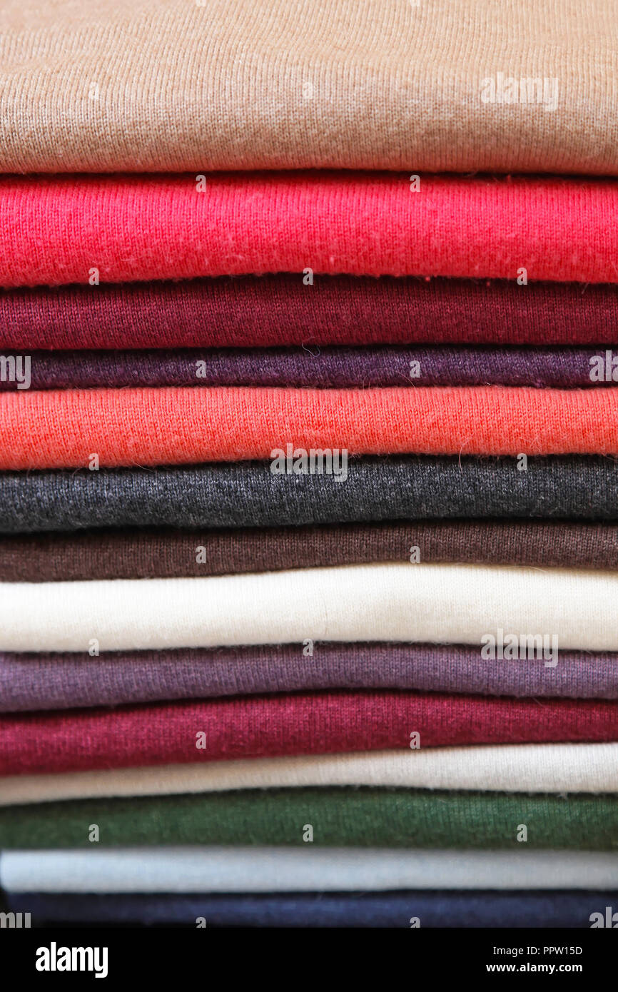 Big pile of vivid color jumpers and sweaters Stock Photo