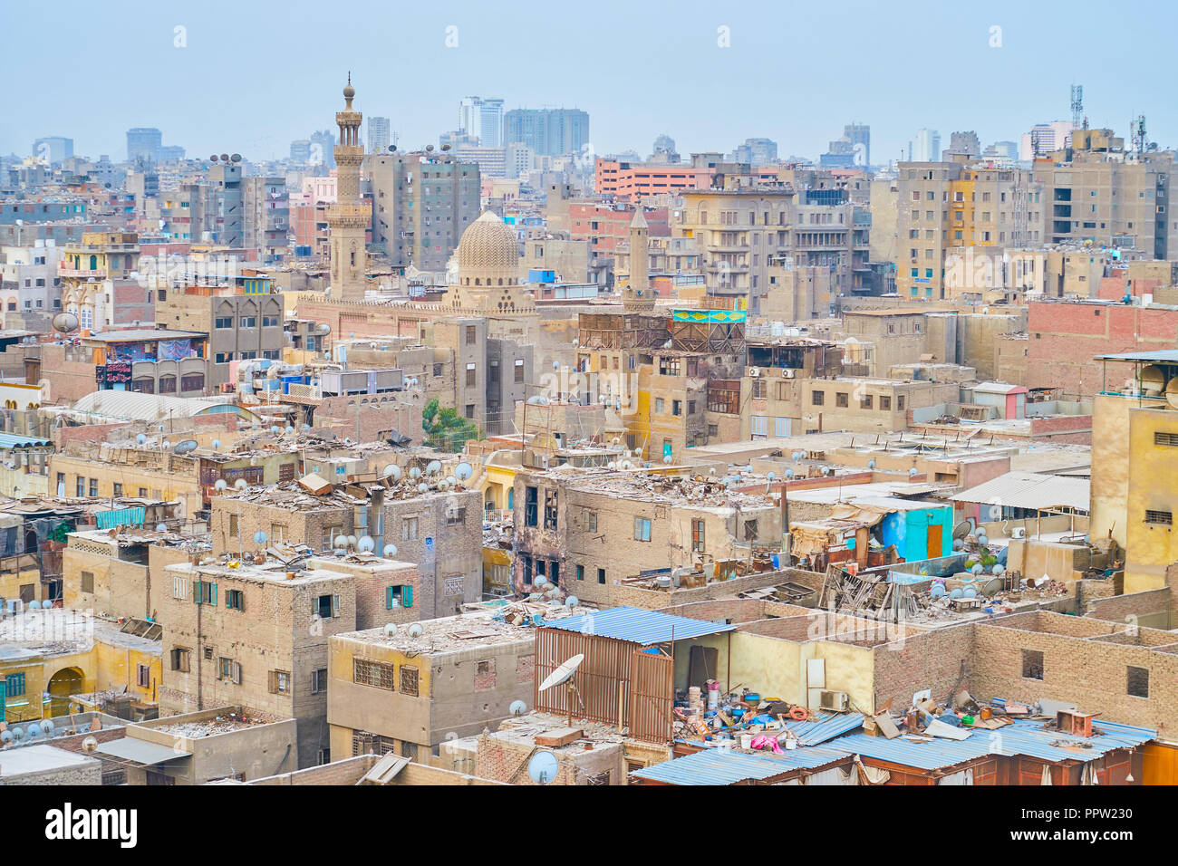 The old shabby houses in historical islamic neighborhood of Cairo with AlAshraf Mosque on the