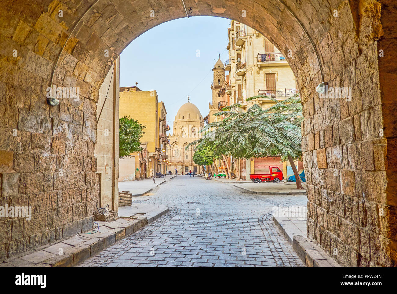 Walk along empty street in morning Cairo with the view on huge historical Qalawun Complex on Al-Moez Street, Egypt Stock Photo