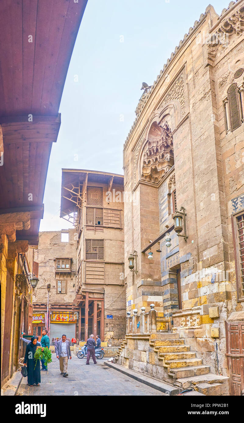 CAIRO, EGYPT - DECEMBER 23, 2017: The narrow street in Islamic Cairo with beautiful iwan of Amir Jamal al-Din al-Ustadar Mosque, on December 23 in Cai Stock Photo
