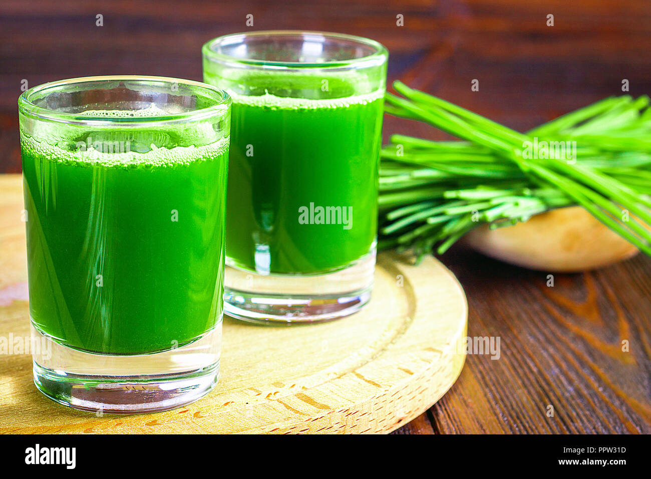 Wheatgrass shot. Juice from wheat grass. Trend of health Stock Photo