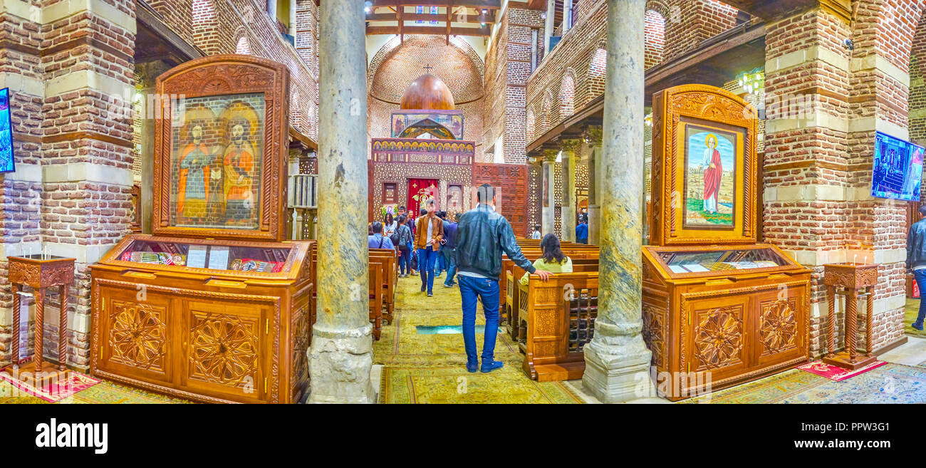 CAIRO, EGYPT - DECEMBER 23, 2017: The panoramic view on the prayer hall of medieval St Barbara Church, decorated with medieval icons in wooden kiots,  Stock Photo