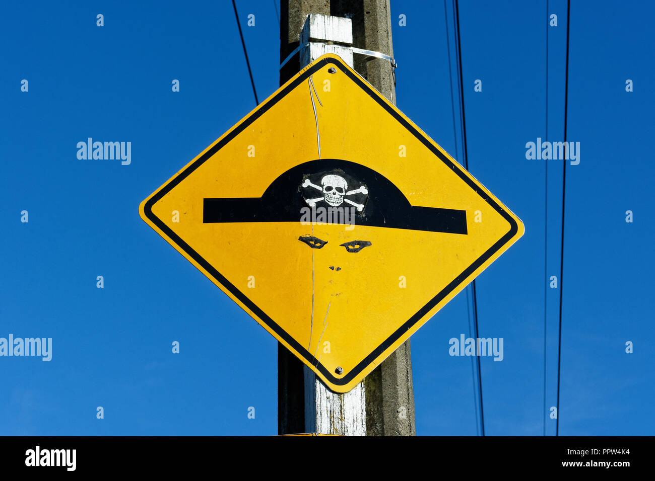 A beware of the speed bump sign has been changed with graffiti to turn it into a pirate Stock Photo