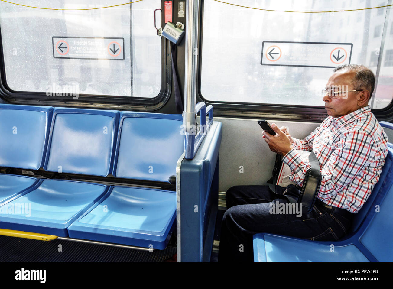 Miami Beach Florida,Miami-Dade Metrobus,inside onboard,Hispanic man men male,rider passenger,FL180527012 Stock Photo