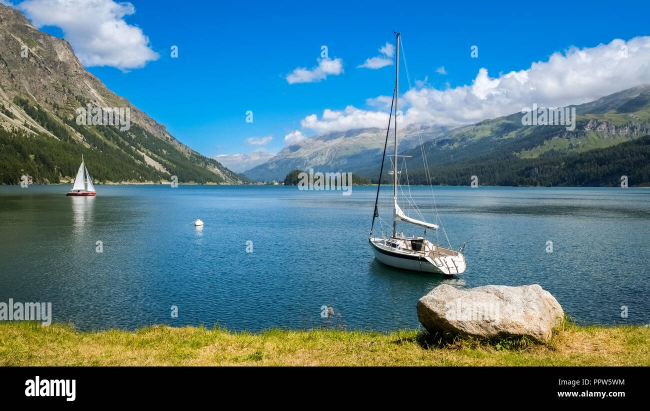 Boats floating on Lake Silvaplana (or Silvaplanersee; Lej da Silvaplauna), a lake in the Upper-engadin valley of Graubunden, Switzerland Stock Photo