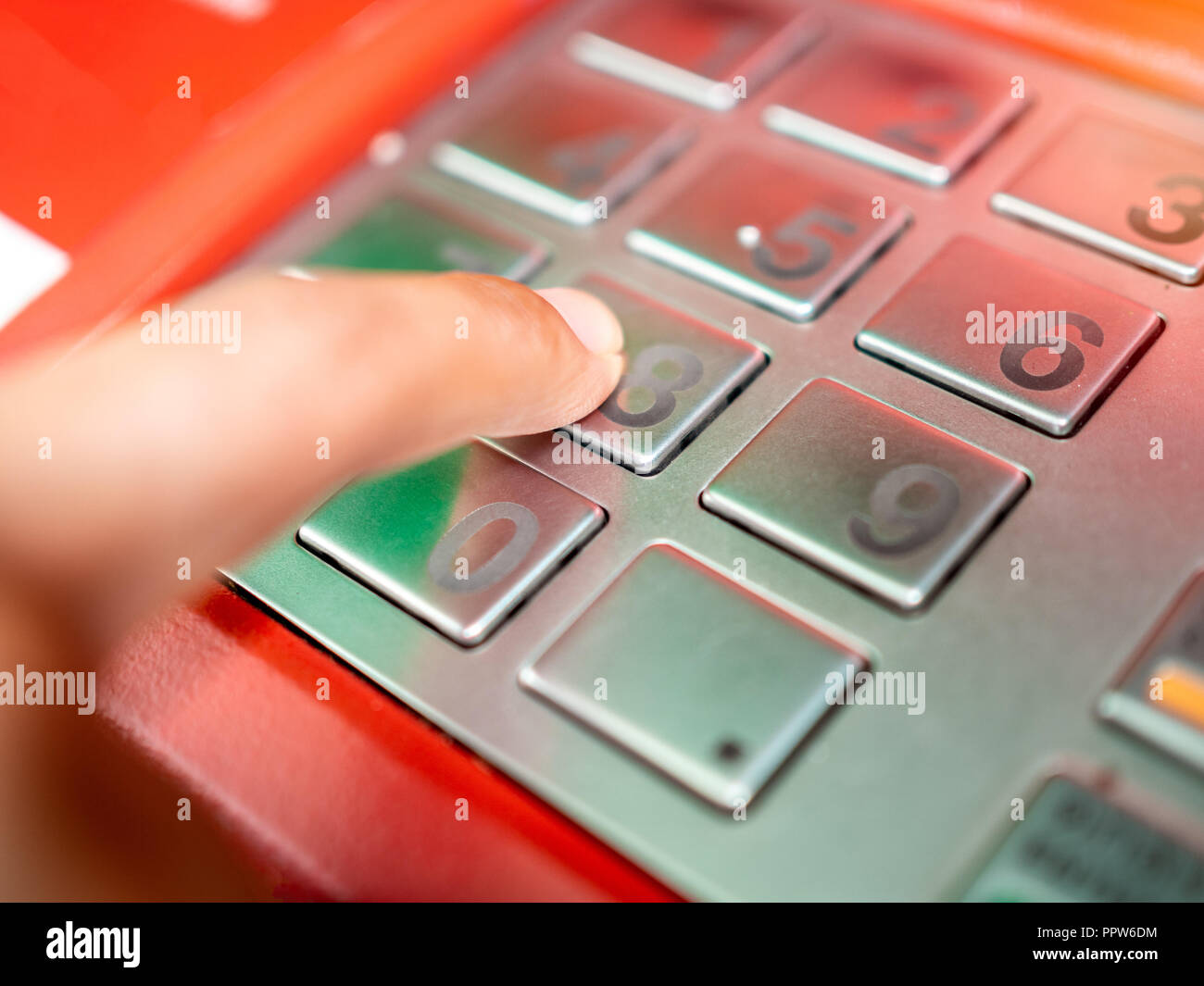 Close up finger inserting password on ATM machine. Hand entering ...