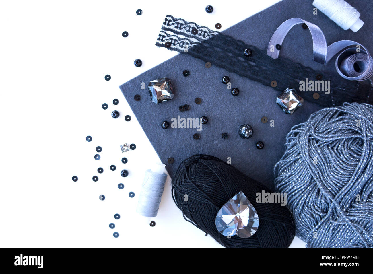 A set of materials for needlework in grey color on a white background. Stock Photo