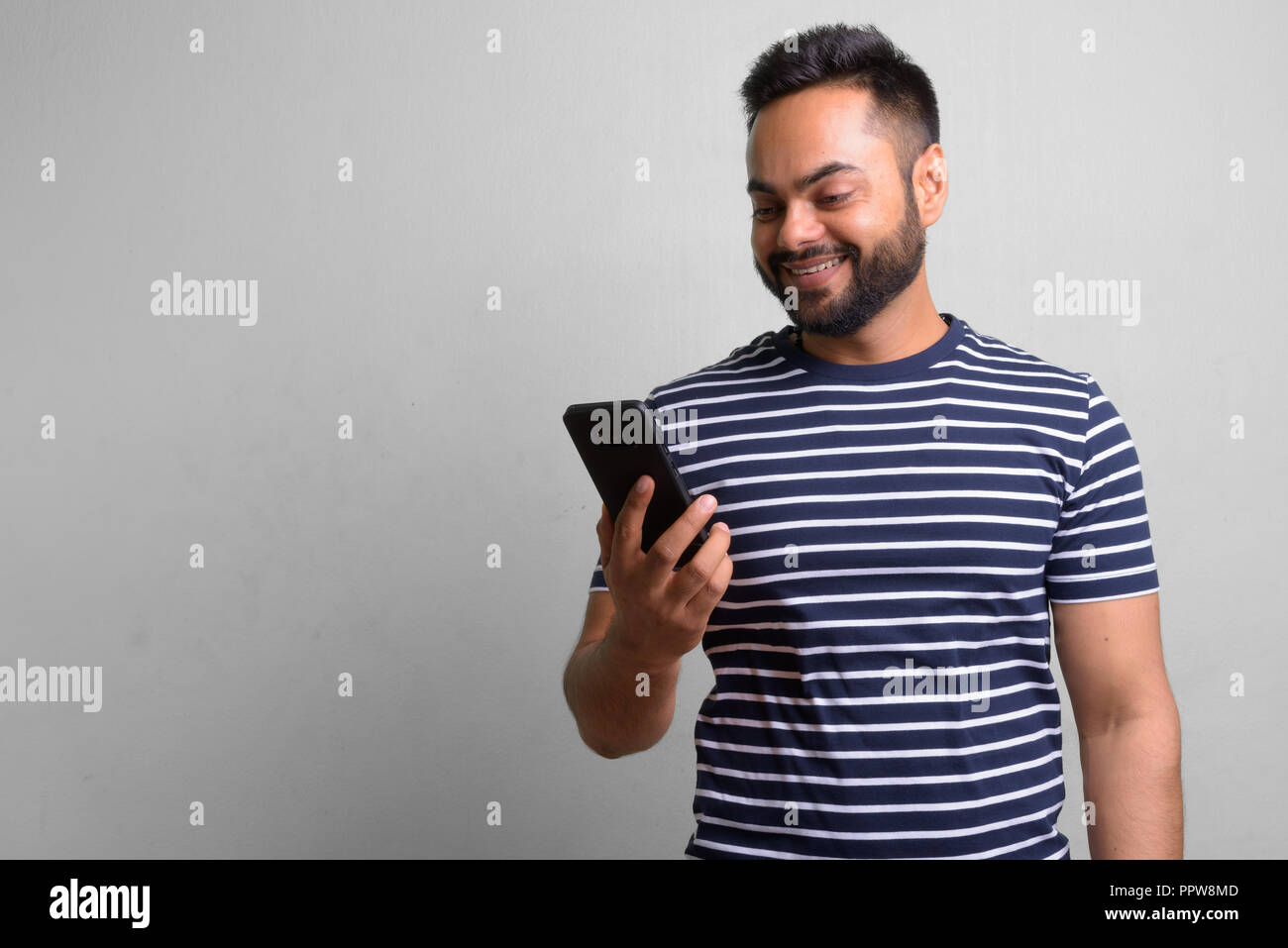 Young bearded Indian man against white background Stock Photo - Alamy
