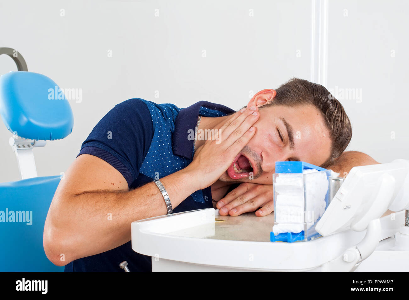 Crazy patient sitting in a dental chair Stock Photo